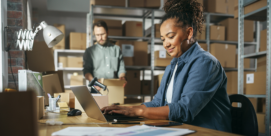 Two people reviewing orders in a warehouse