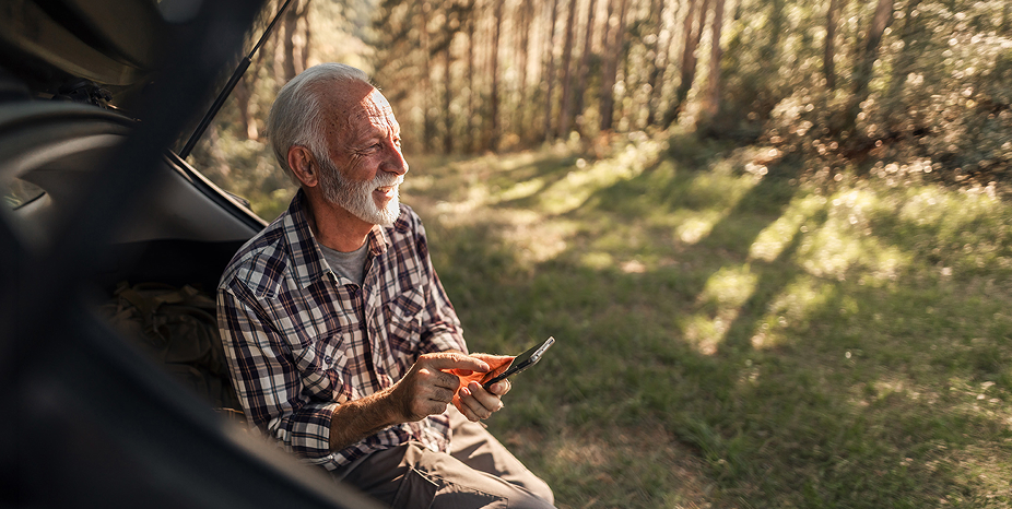 A homeowner using his phone outdoors